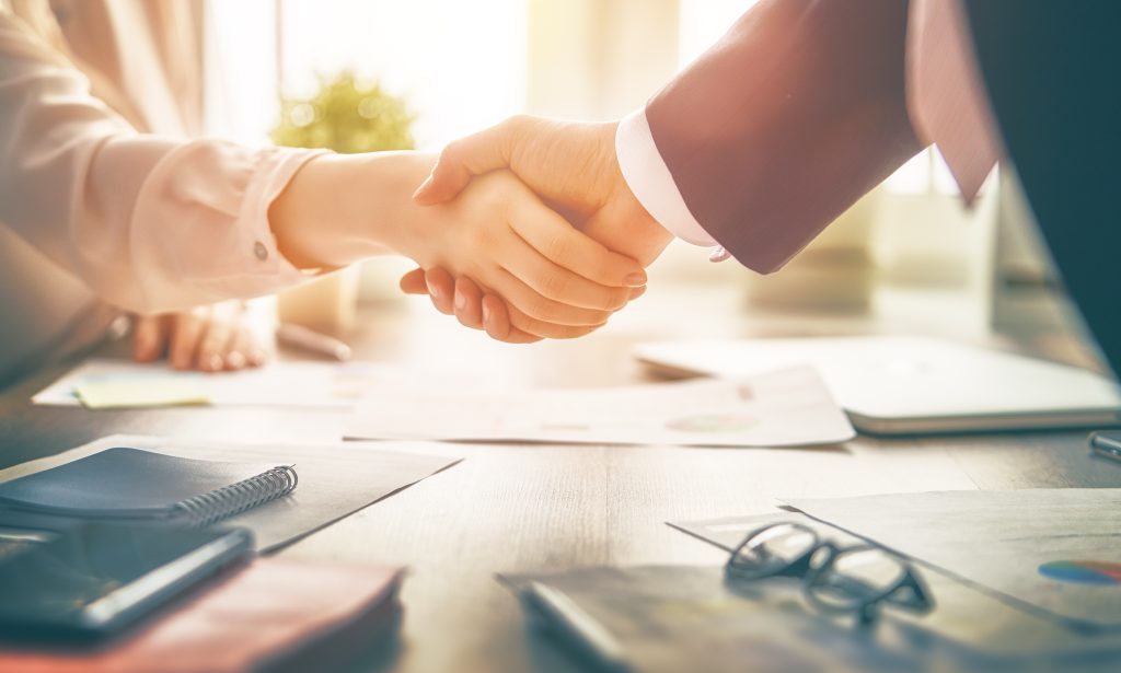 Man,And,Woman,Are,Shaking,Hands,In,Office.,Collaborative,Teamwork.